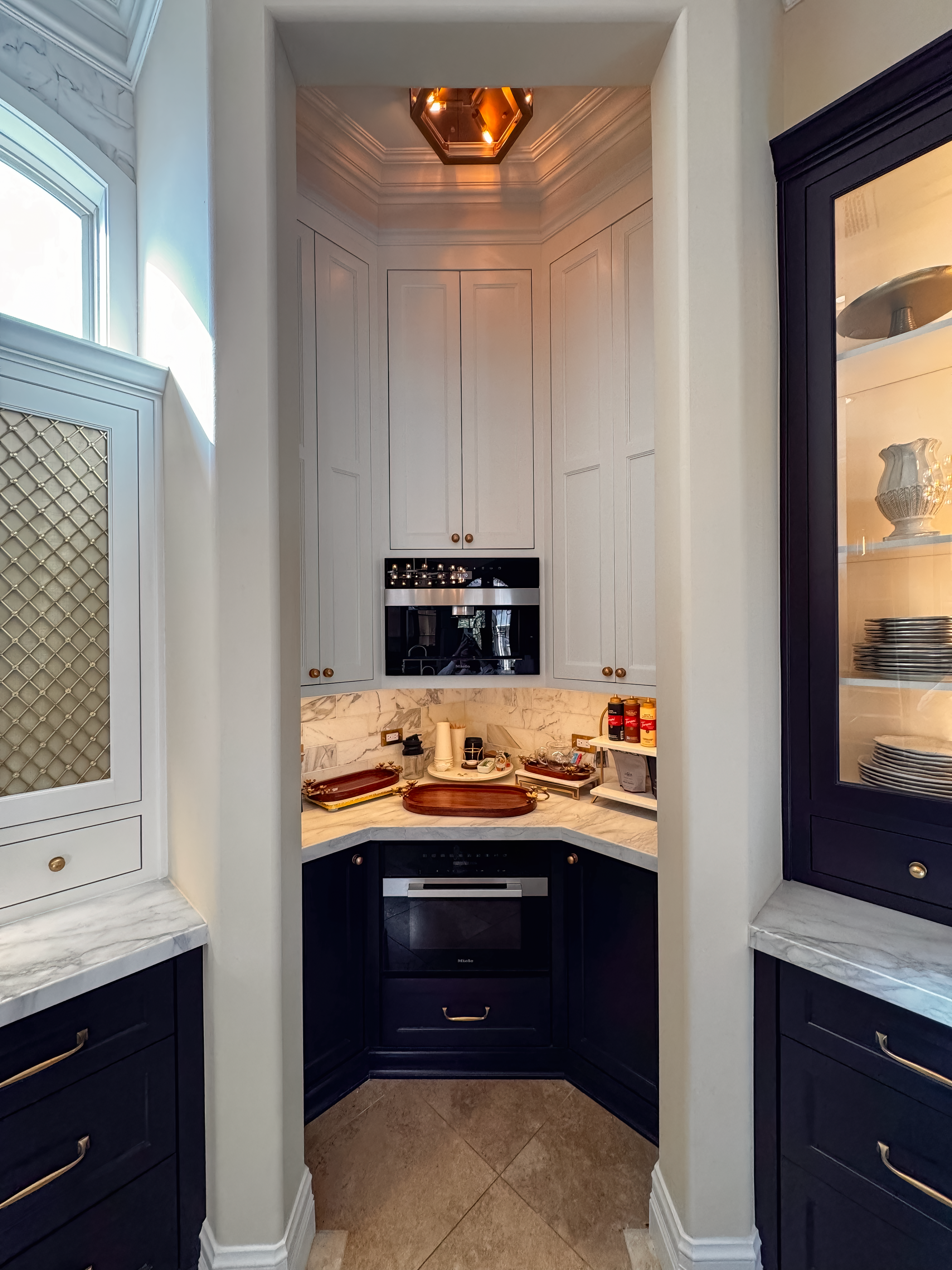 The range wall sheathed in Italian marble from counter to ceiling
