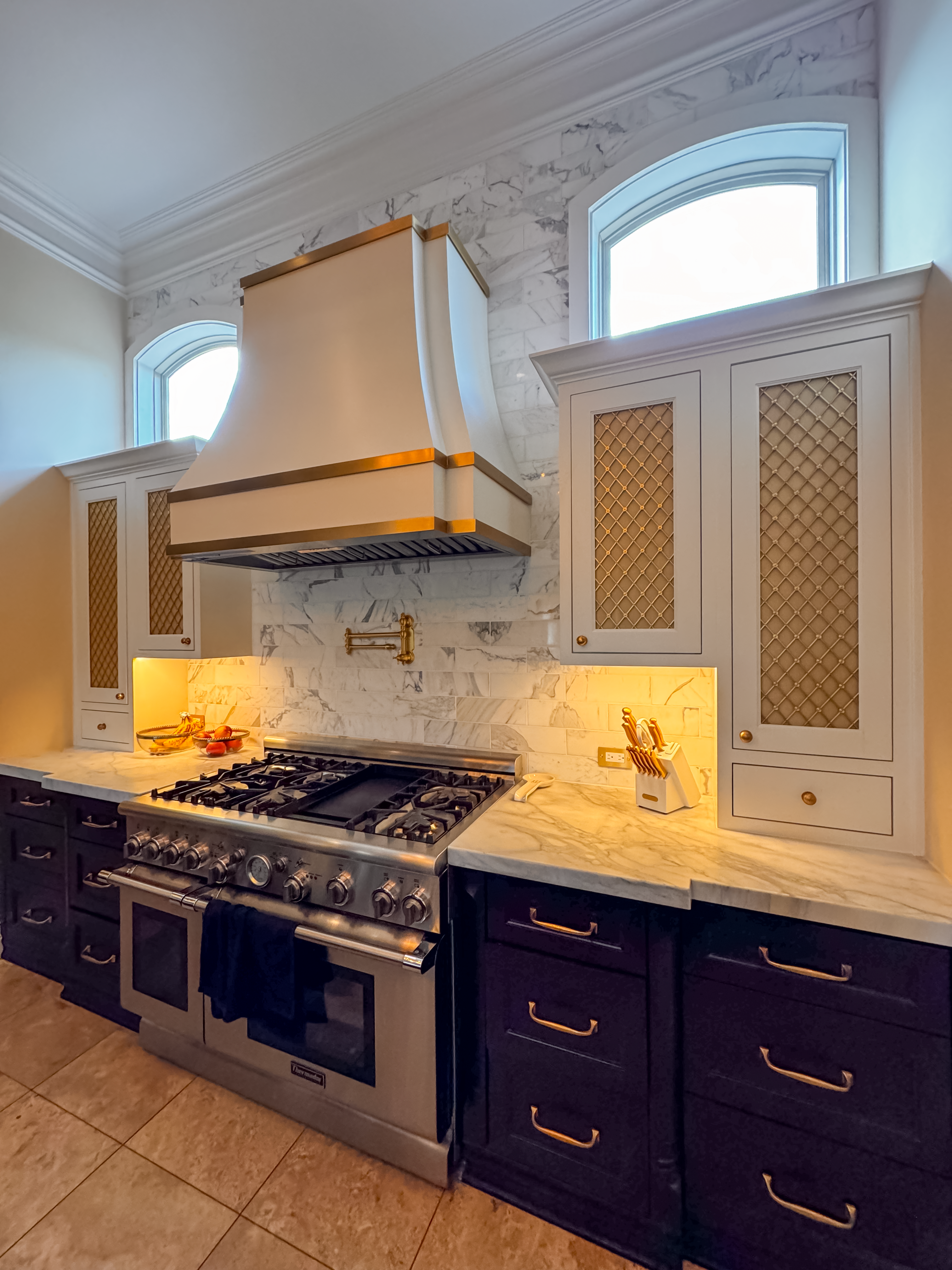 Illuminated glass cabinetry behind lattice grates