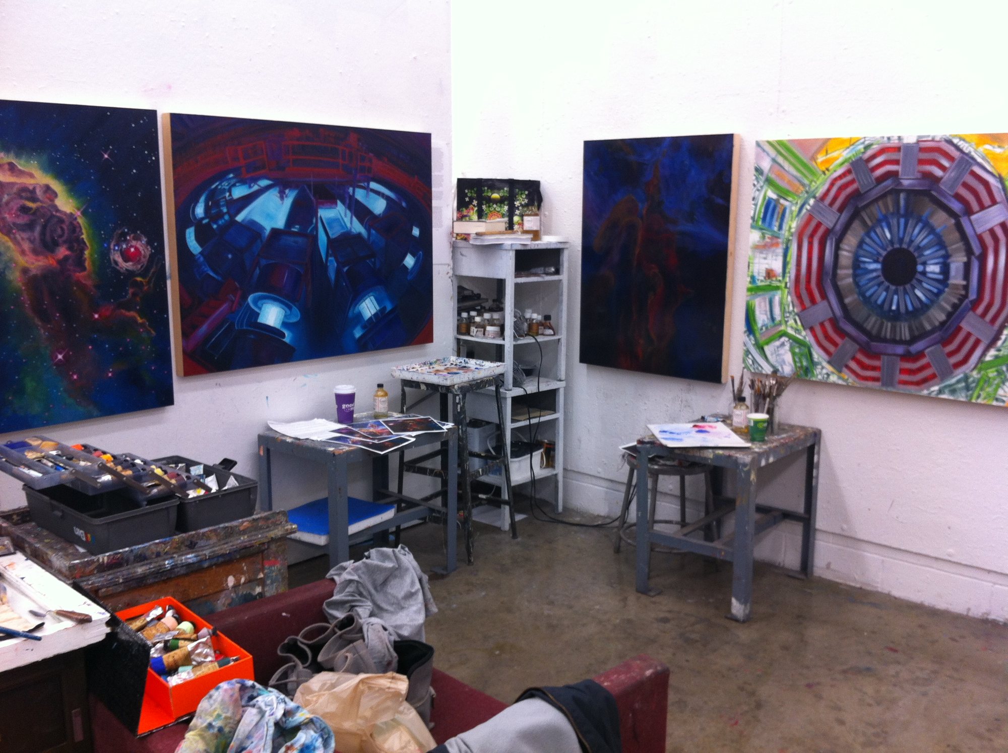 Portrait of Z hanging in the studio alongside the nebula and particle-collider paintings