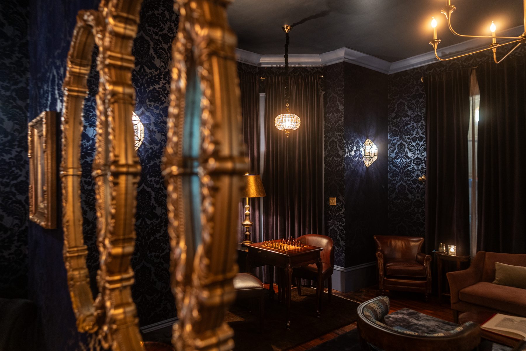 Gilt frames and the chess table beyond