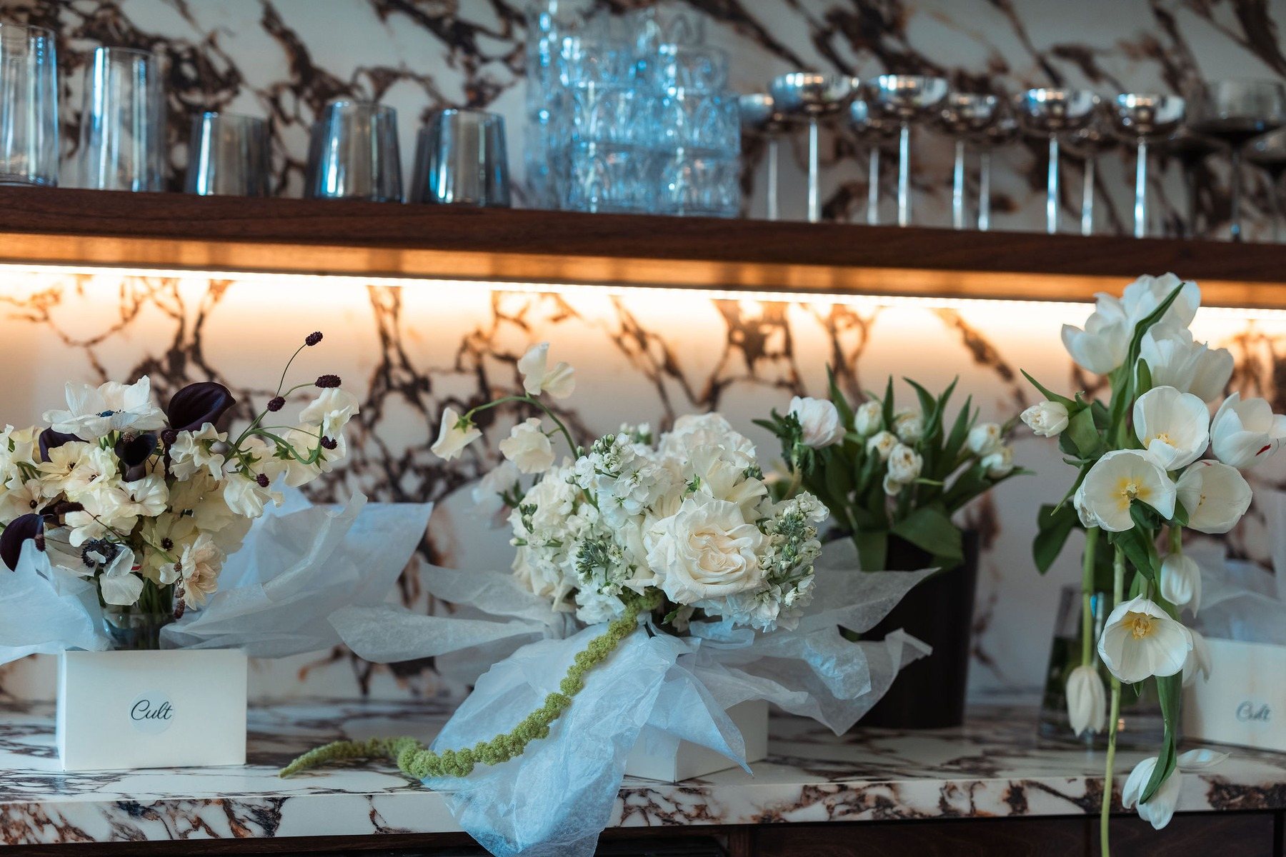 Glasses and flowers set out on the bar
